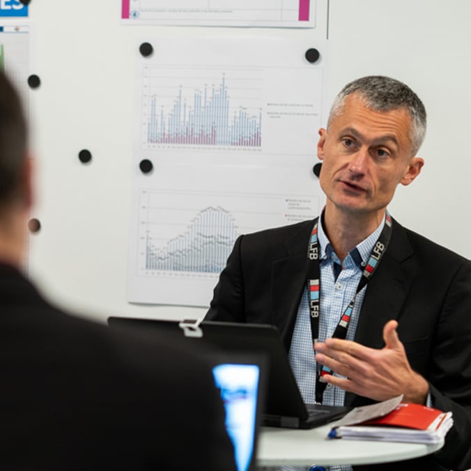 An LFB employee in a meeting room talking to a colleague.